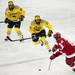 Michigan sophomore center Travis Lynch and junior right wingman Derek DeBlois chase the puck on Saturday. Michigan lost 4-3. Daniel Brenner I AnnArbor.com